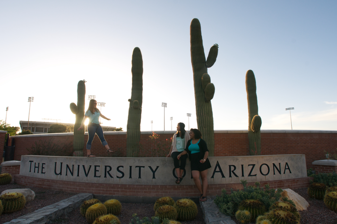 UA students at the stone landmark signage