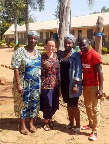 Kayla Mitchell with language host family in Uganda.